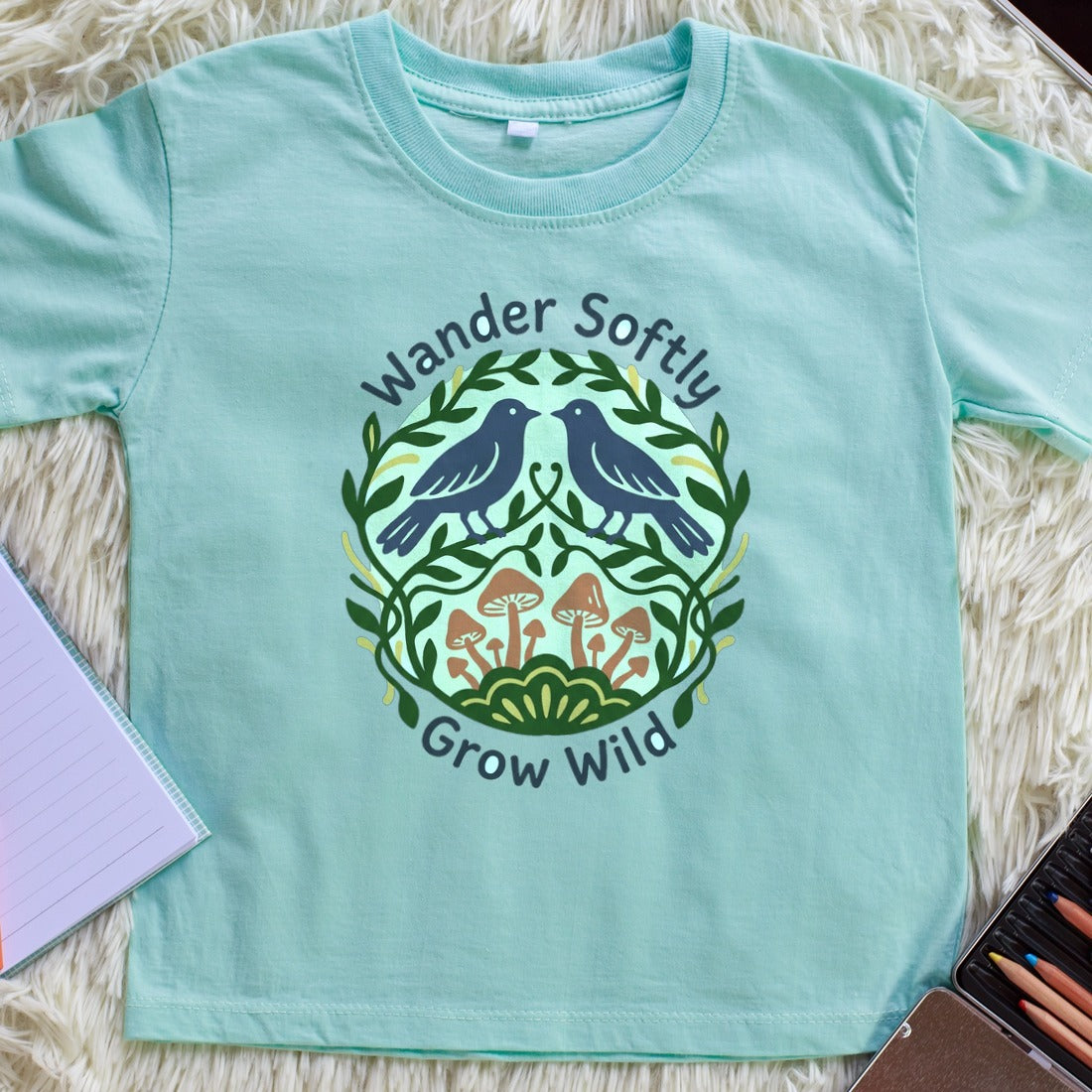 Forest Harmony Folk Art Crest Kids Tee — lifestyle photo