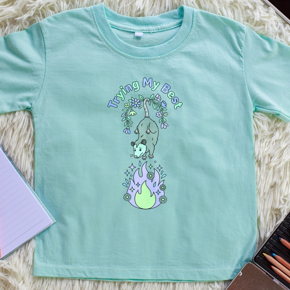 Trying My Best Dumpster Fire Opossum Kids Tee — lifestyle photo