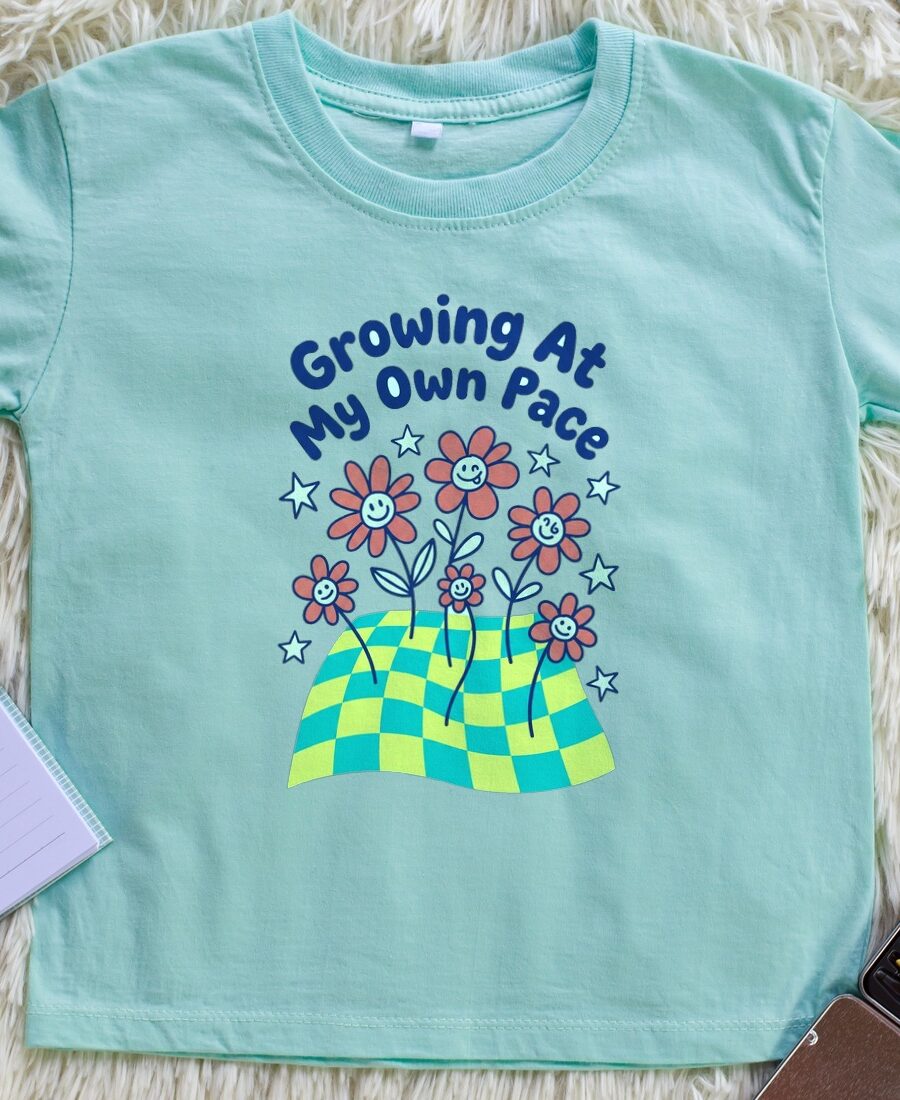 Growing At My Own Pace Wobbly Garden Kids Tee — lifestyle photo