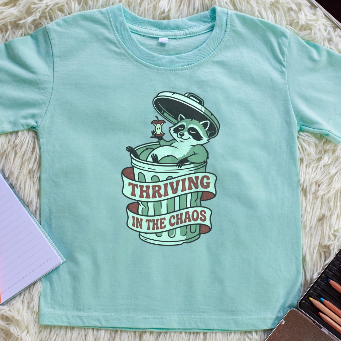 Thriving In The Chaos Raccoon Tee Kids Tee — lifestyle photo
